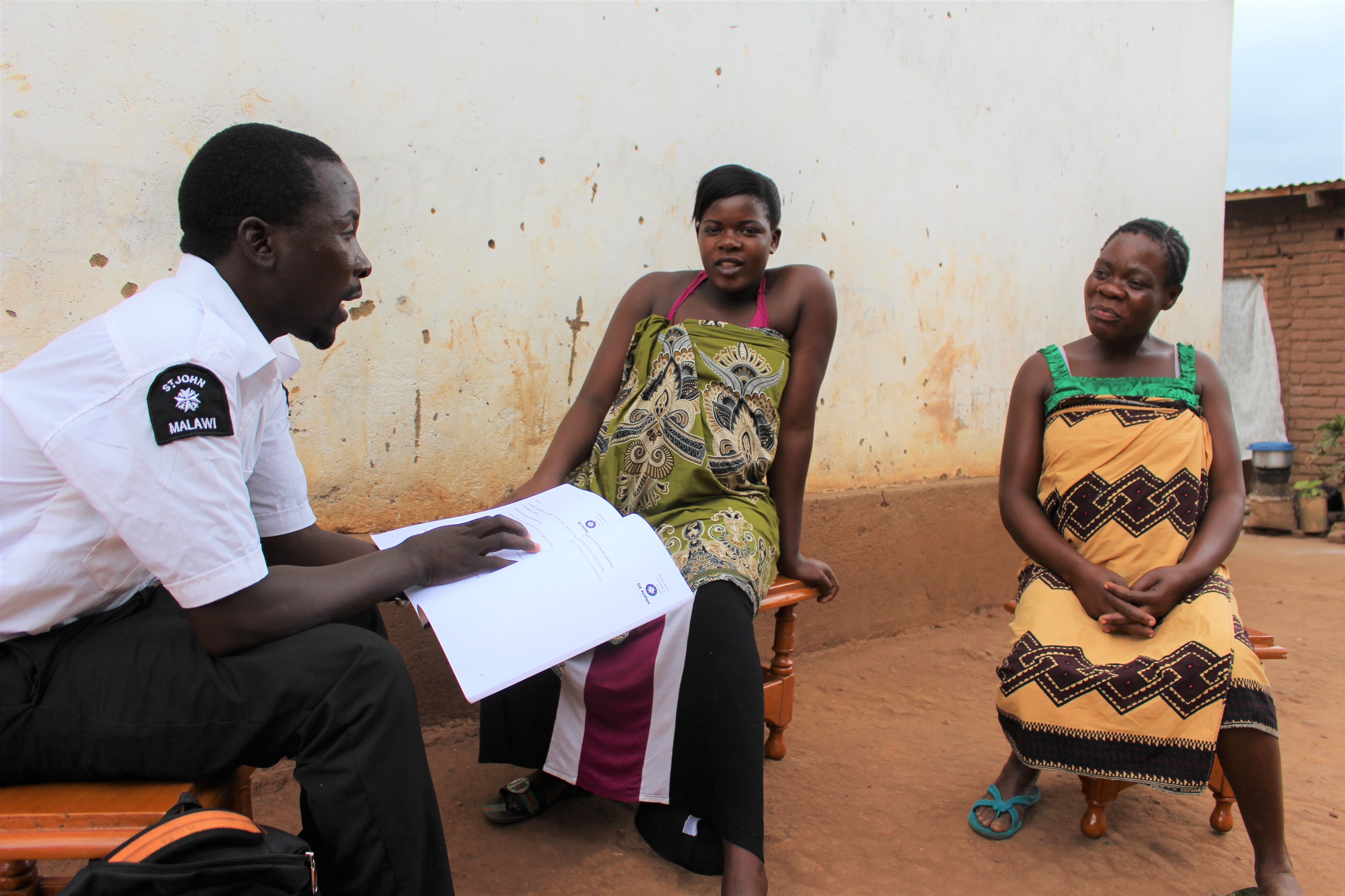 Photo of a doctor speaking to two women