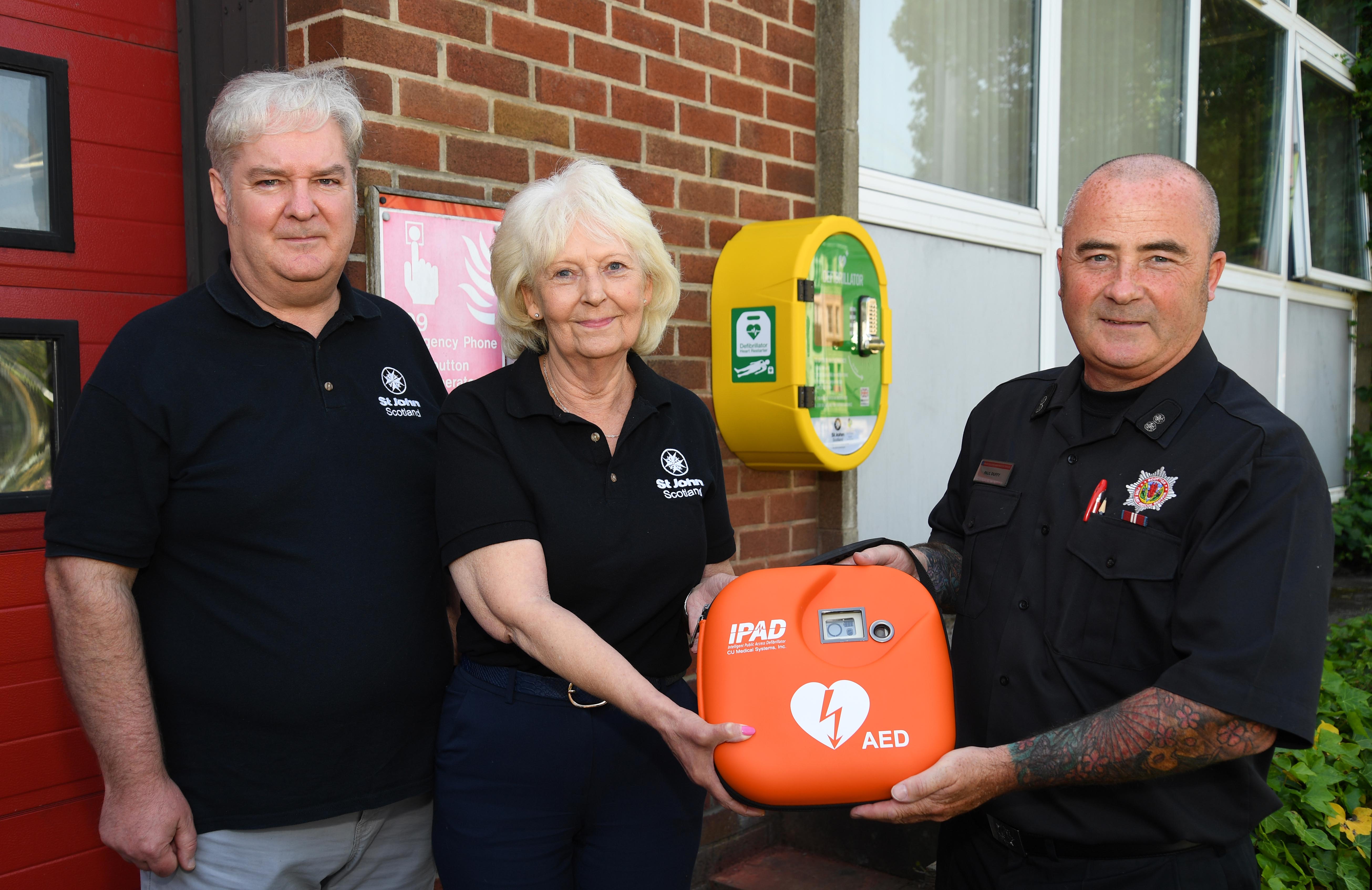 Photo of a fire station receiving a defibrillator 