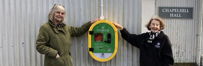 Photo of volunteers with a defibrillator
